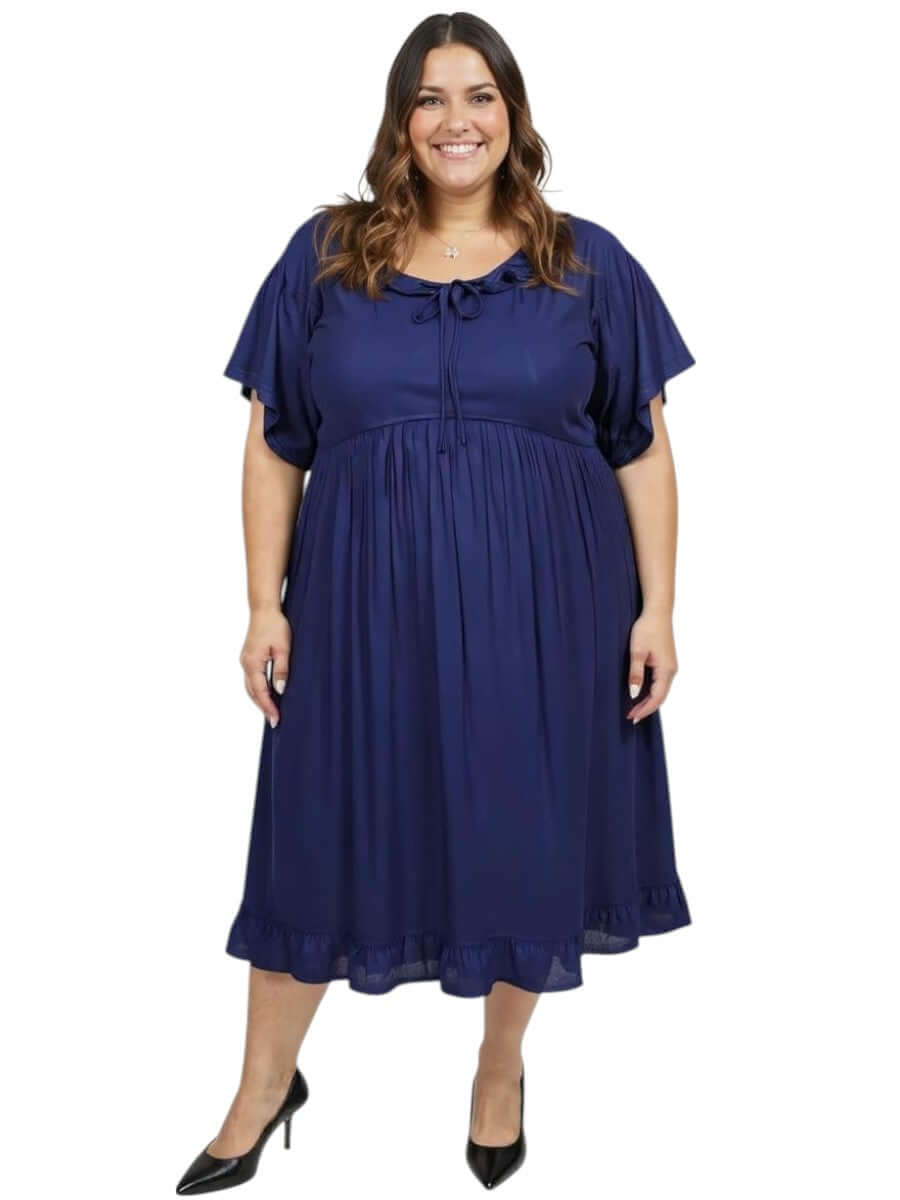Dale and Waters Women's Plus Size Trinity Dress in Navy with ruffled hem and tie detail, featuring a relaxed fit and flattering silhouette.