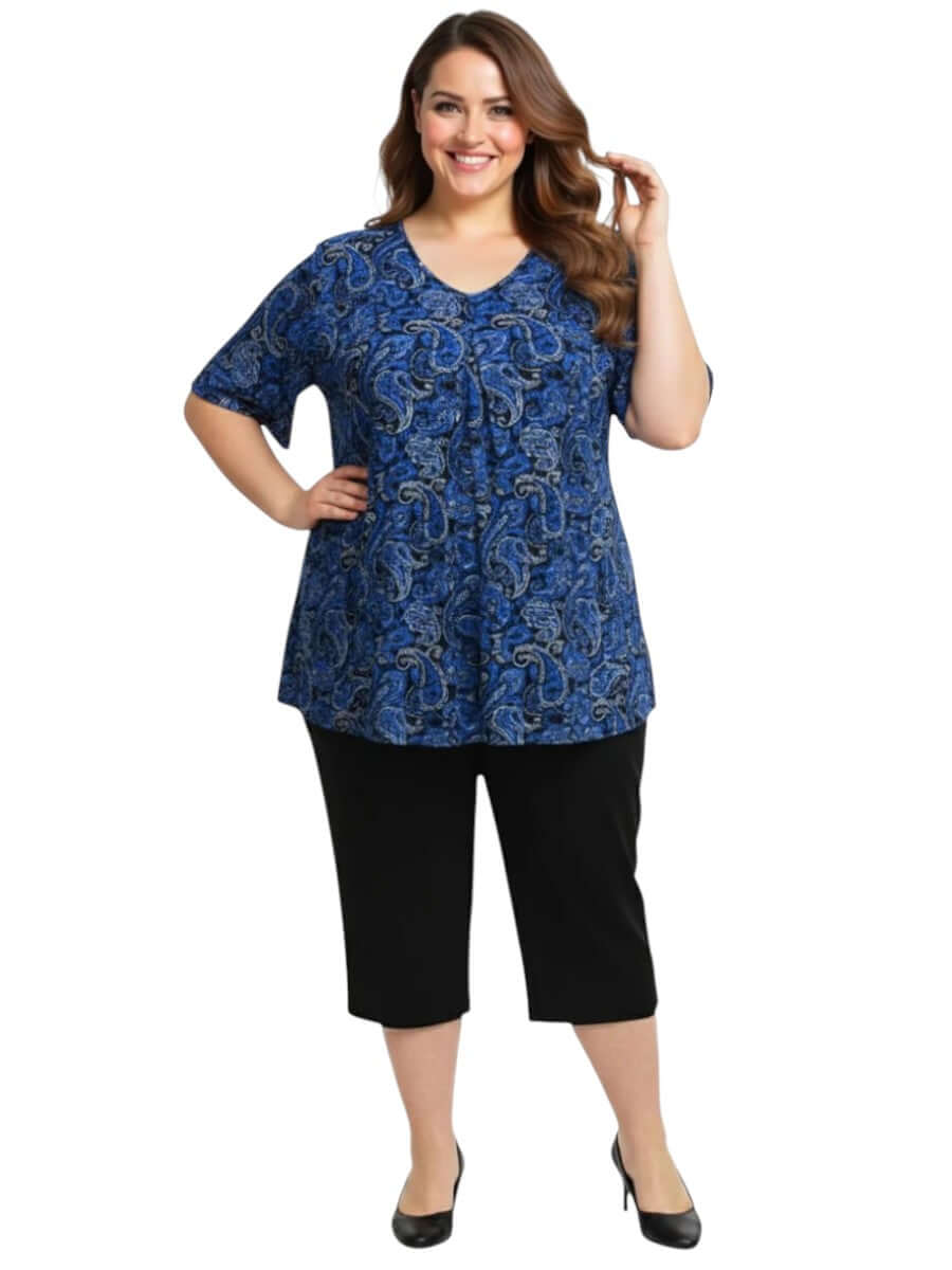 Westin Top - Blue worn by woman in plus size, displaying royal blue paisley print and V-neckline.