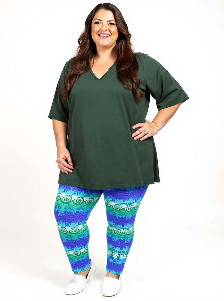 Atlas Leggings - Purple Print worn by a plus size woman showcasing casual style and comfort.