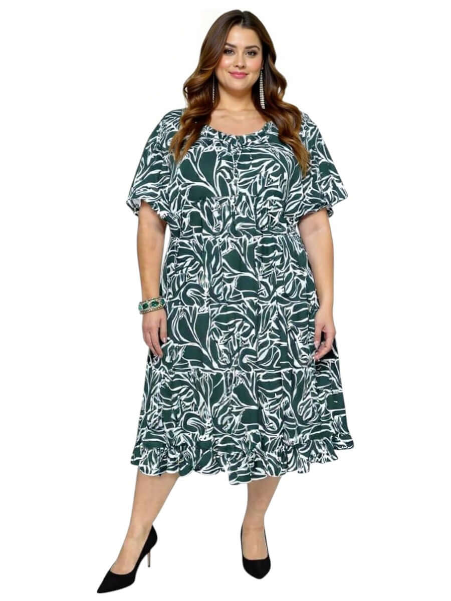 Women’s Plus Size Trinity Dress by Dale and Waters in green and white print with ruffle hem and relaxed fit sleeves.