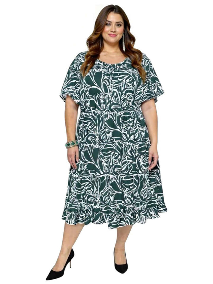 Women’s Plus Size Trinity Dress by Dale and Waters in green and white print with ruffle hem and relaxed fit sleeves.