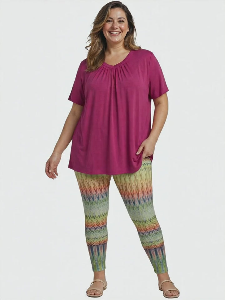Women in plus size Montez Top - Pink paired with colorful leggings, showcasing women's fashion. Size 16 to 504.