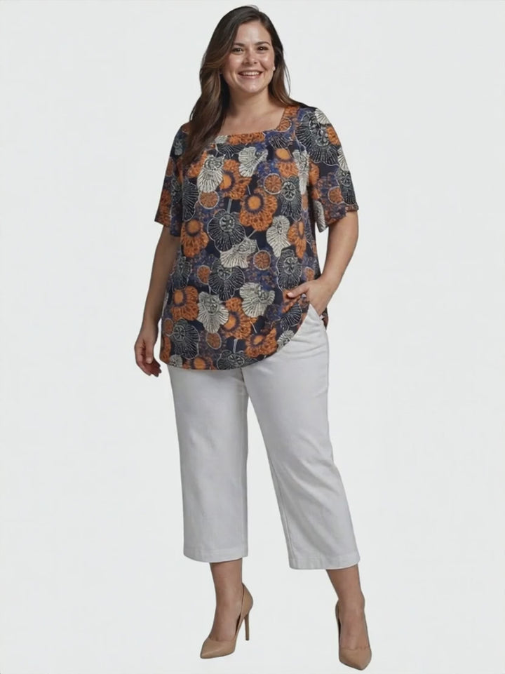 Lora Top - Navy Print worn by a model, showcasing its floral design and relaxed silhouette, plus size women's fashion.