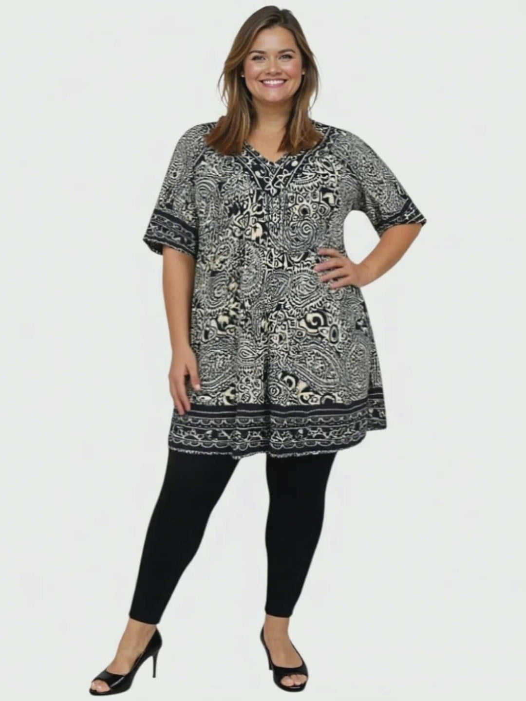 Model wearing Sterling Fields Tunic - Black Print with leggings, showcasing plus size fashion and comfort.