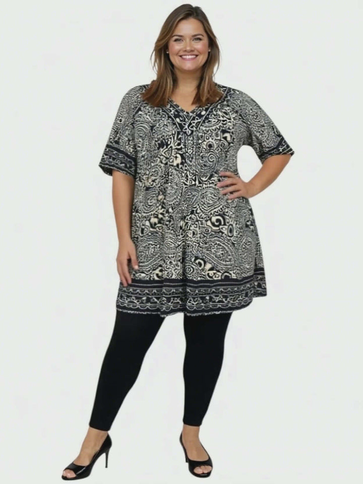 Model wearing Sterling Fields Tunic - Black Print with leggings, showcasing plus size fashion and comfort.