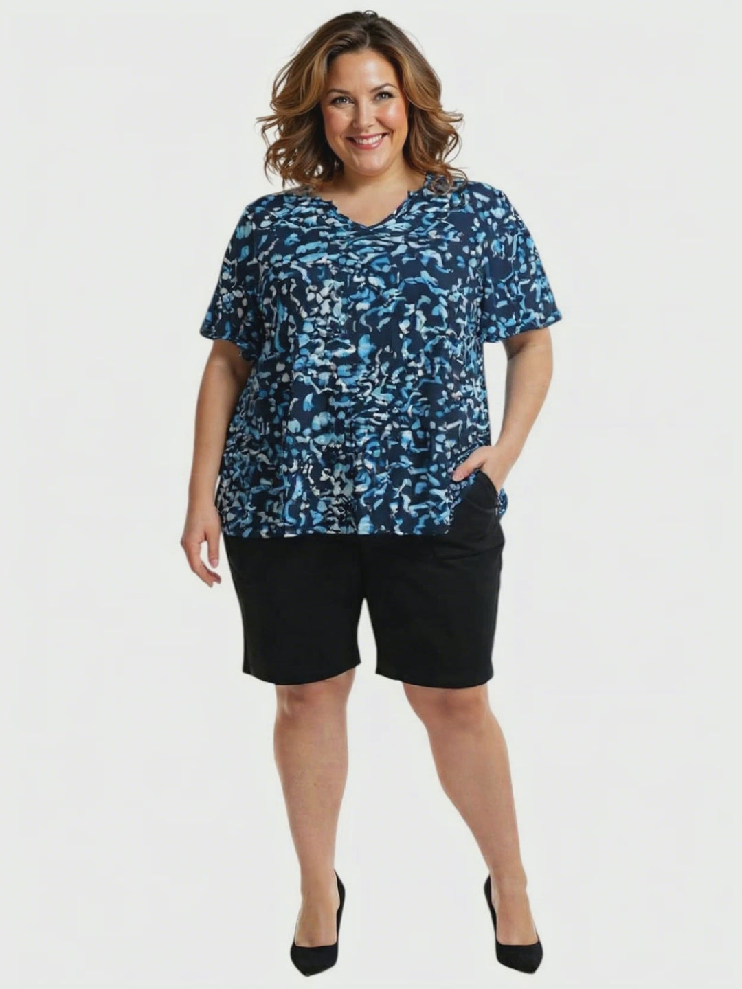 Ocean Top - Blue Print worn by a plus size woman, featuring navy and ocean blue abstract print, relaxed fit with V-neckline.