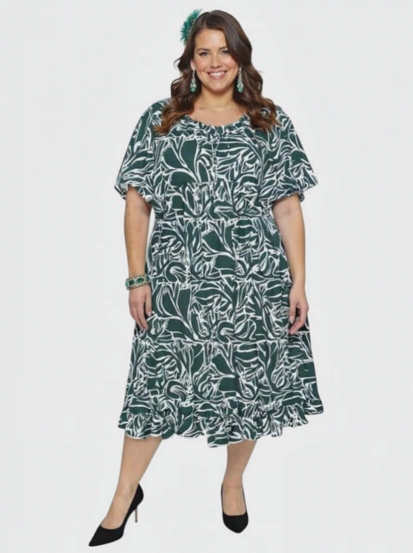 Dale and Waters Women’s Plus Size Trinity Dress in Green Print, featuring short raglan sleeves and a flowing babydoll silhouette.