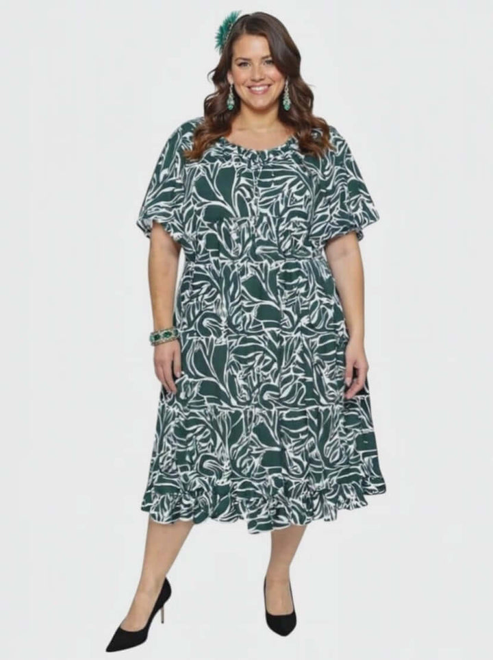 Dale and Waters Women’s Plus Size Trinity Dress in Green Print, featuring short raglan sleeves and a flowing babydoll silhouette.