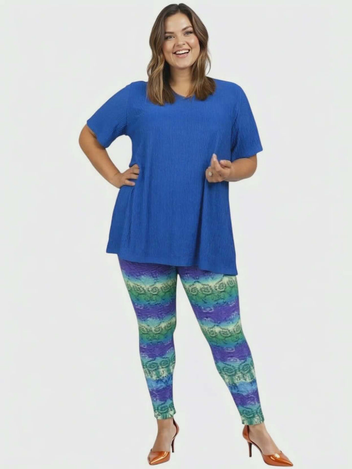 Model wearing the Melany Top - Royal Blue with colorful patterned leggings, showcasing effortless style and comfort.