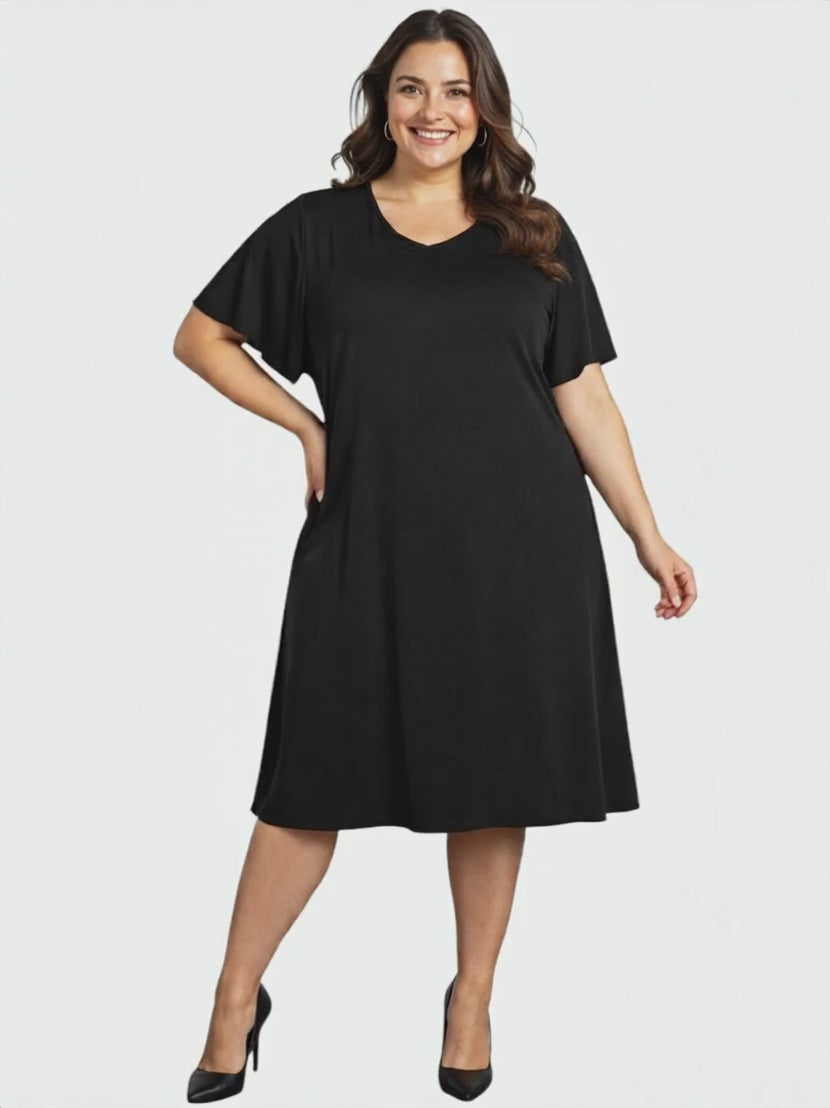 Westley Dress - Black on a model showcasing women fashion in plus size with a relaxed, A-line silhouette.