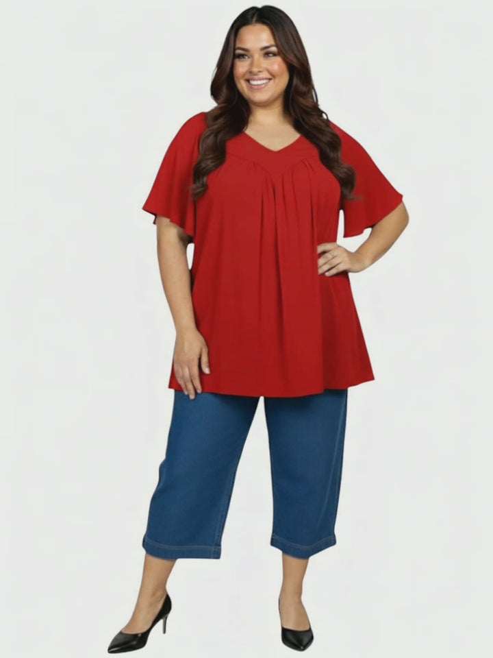 Leeman Top - Red: Plus size women's tunic in ruby red by Dale and Waters, size 16-50, featuring flattering drape and deep V-neck.