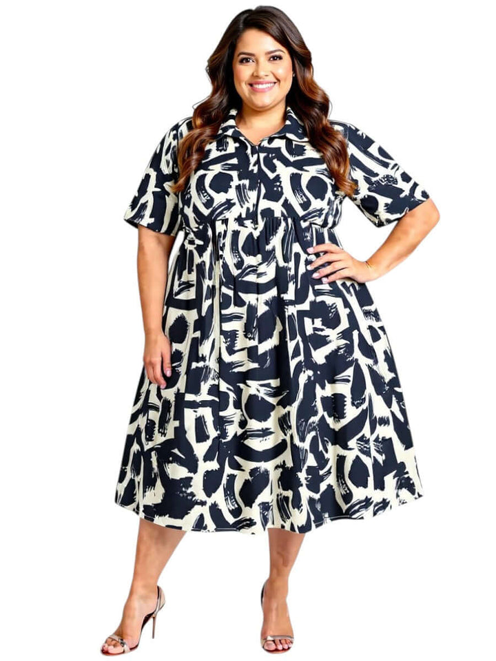 Plus size woman in a black and cream print Johanna dress by Dale and Waters, featuring collared design and 3/4 sleeves.