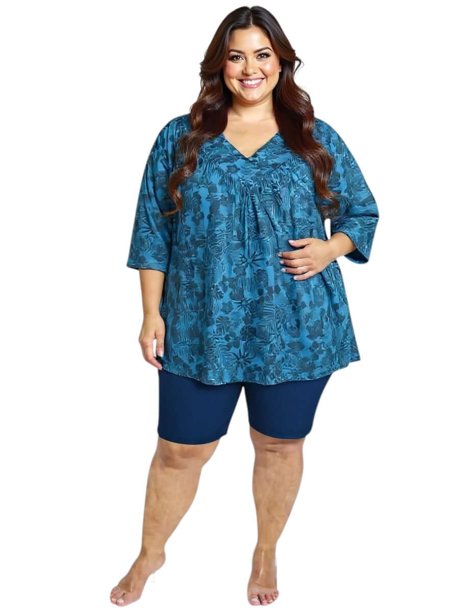 Women’s Plus Size Shadow Tropics Swim Rashi in teal print, featuring V-neck and ¾ sleeves, by Dale and Waters.