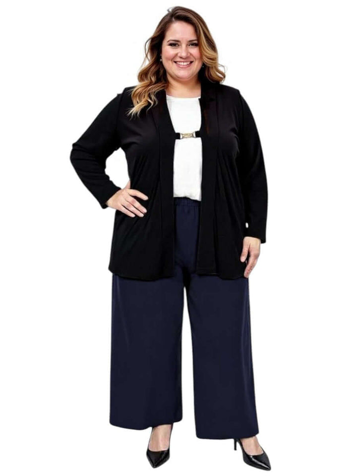 Plus size woman modeling the Mercedes E2E Cardi in black, styled with a white top and navy wide-leg pants.